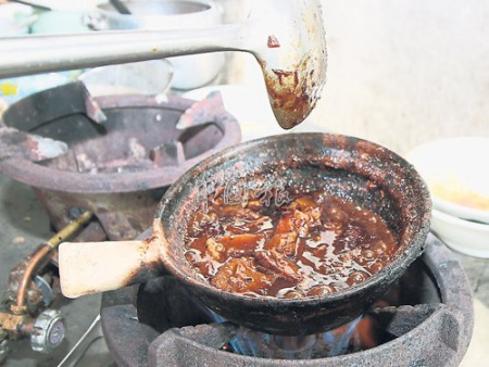 东坡肉焖煮时散发出浓郁汤汁及味道，让人垂涎三尺。（马来西亚《中国报》/张嘉佩 摄）