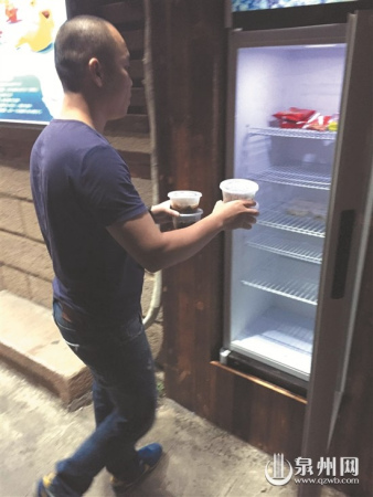 牛肉馆工作人员往冰箱里存放食品 牛肉馆工作人员往冰箱里存放食品
