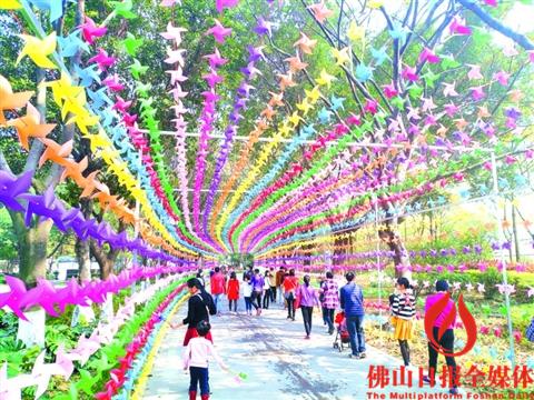 三水荷花世界,市民穿过长达数百米的风筝长廊。 /佛山日报记者杨立韵摄 三水荷花世界,市民穿过长达数百米的风筝长廊。 /佛山日报记者杨立韵摄