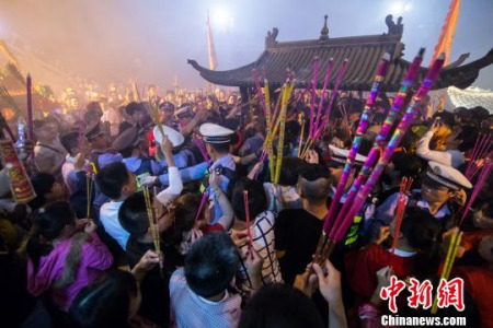 18日晚,妈祖信众每人手持香火,将祖庙香炉围得里外三层,等待零点时分的到来。 李南轩 摄 18日晚,妈祖信众每人手持香火,将祖庙香炉围得里外三层,等待零点时分的到来。 李南轩 摄