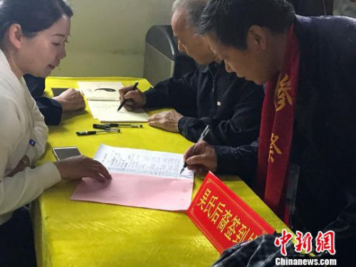 图为两岸吴氏宗亲在季子庙中签到。 杨颜慈 摄 图为两岸吴氏宗亲在季子庙中签到。 杨颜慈 摄