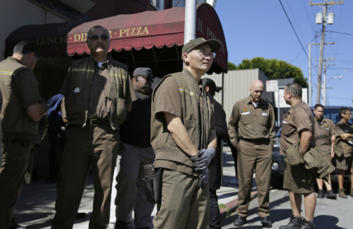 旧金山枪击案发生后，UPS员工走出工厂。(美国《世界日报》/美联社图片)