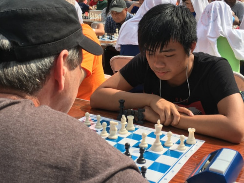 杨伟君在比赛中，与西洋棋公开赛段位高手过招。(美国《世界日报》 李硕/摄)