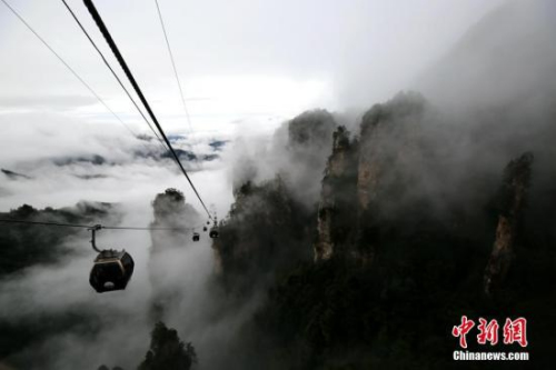 10月5日，“十一”国庆假期的第五天，雨中的湖南张家界武陵源风景区现云雾景观，山峰被随风飘舞的云雾所缠绕，宛若一幅水墨画。来自武陵源区旅工委办公室的消息称，目前武陵源各景区接待正常，秩序井然。 吴勇兵 摄