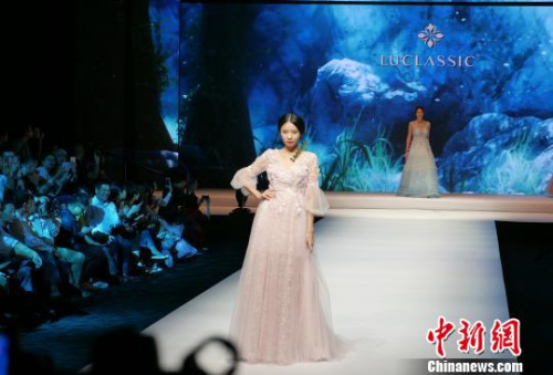 广东潮州举办国际婚纱礼服周,连续上演十余场婚纱礼服秀,展示中国最新婚纱礼服潮流。 陈启任 摄 广东潮州举办国际婚纱礼服周,连续上演十余场婚纱礼服秀,展示中国最新婚纱礼服潮流。 陈启任 摄