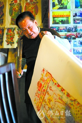冯炳棠生前在作坊内印制木版年画。（资料图片） 佛山日报记者张弘弢摄
