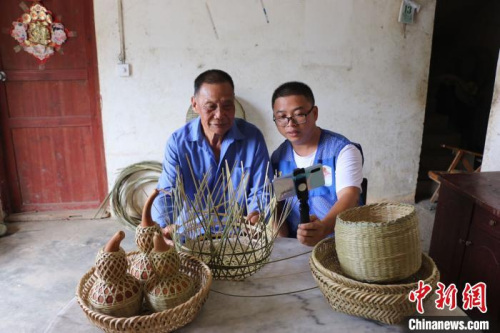 梁福年通过网络直播方式帮助苏国厚销售竹编助增收。　钟鸣 摄