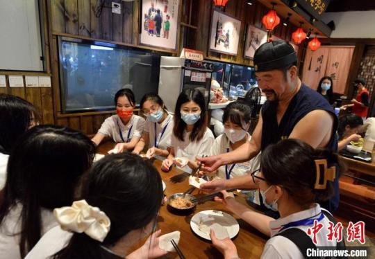 图为同利肉燕传人陈君凡向研学体验营的学生传授包肉燕技艺。　张斌 摄