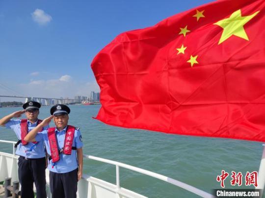 厦门东渡边检站船艇执勤队队员执勤中向国旗敬礼。　张茂鑫 摄