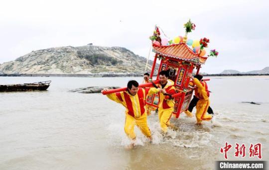 信众抬着神轿冲海祈福。　陈斌 摄