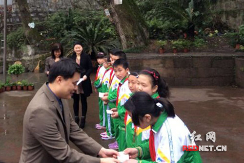 中国侨网在文昌阁小学,谭长生为八名学生颁发奖学金。