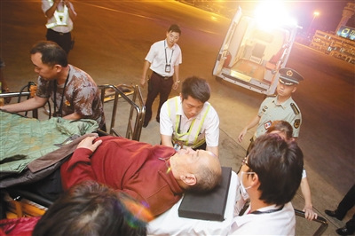 中国侨网图为凤凰机场急救人员在转运高老先生。（《海南日报》/武威 李鹏程 摄）