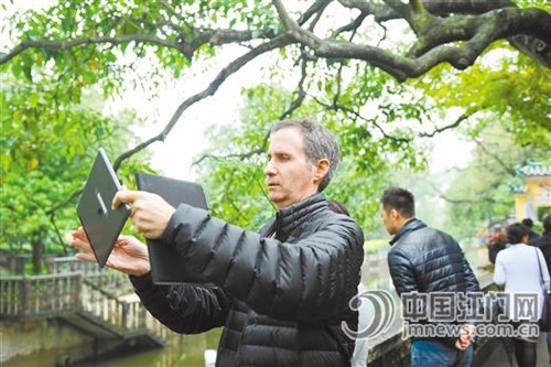 中国侨网Mark Gordon在参观开平碉楼时全程拍摄小视频,对侨乡的建筑文化很是赞赏。(《江门日报/黄宇舰 关君 摄》))