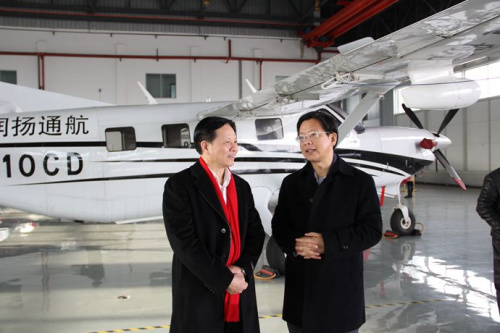 中国侨网镇江市侨办主任魏弘扬（右）向范群博士介绍航空航天政策