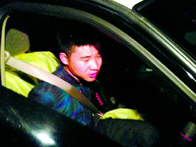 中国侨网周远在高速公路飙车逃逸时被警方逮捕并押上警车。(美国《侨报》)