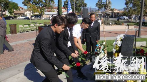 中国留学生向中美二战纪念碑献花。（美国《侨报》/高睿