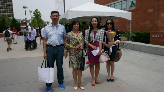缪鼐(右一)和周爱民(左一)前来参加家人的毕业礼。（美国《世界日报》/李雪