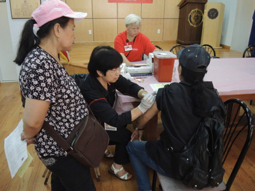 “福安康宁”华人小区保健计划护士为民众接种流感疫苗。(美国《世界日报》/高梦梓