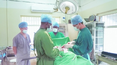 7月17日，驻扎在坦桑尼亚奔巴岛的无锡市第二人民医院杨晓医生（右一），在为一位摔伤的七岁小患者进行骨科手术。
