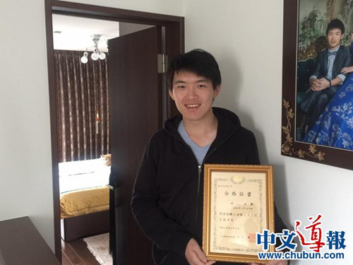 何彦徵手捧司法考试合格证书(日本《中文导报》)
