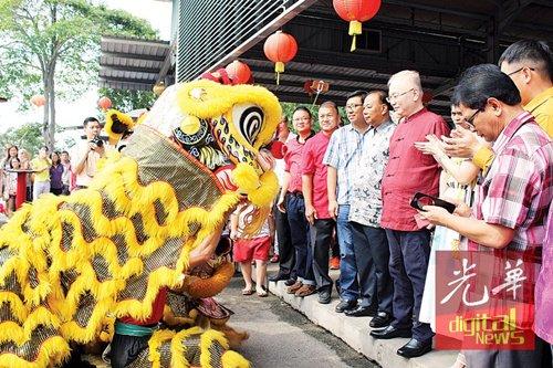中国侨网魏家祥(左5)在新春门户开放活动上,观赏舞狮表演。(马来西亚《光华日报》)