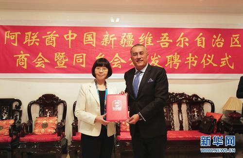 中国侨网 3月13日,在阿联酋迪拜,中国驻迪拜总领事李凌冰(左)向阿联酋中国新疆维吾尔自治区商会暨同乡会会长阿不来提颁发聘书。 新华社记者李震摄