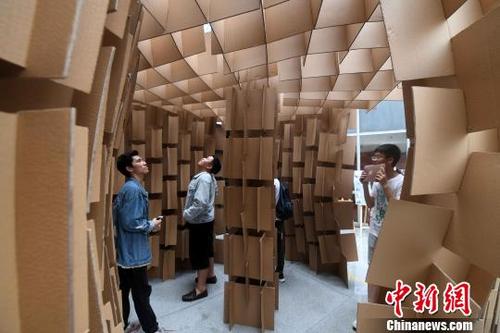 中国侨网5月13日,学生们在体验参加比赛选手搭建的“房屋”。 张斌 摄