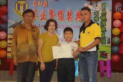 中国侨网死者黄晓梅(左2)和儿子王嘉胜(右2)日前出席一项颁奖礼摄。(马来西亚《星洲日报》档案照)