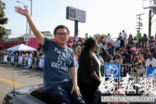 中国侨网资料图：美国加州州长选举惟一华裔候选人江俊辉，在游行队伍中向观众挥手致意。(美国《侨报》/邱晨 摄)