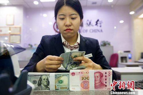 中国侨网资料图：银行工作人员清点货币。中新社记者 张云 摄