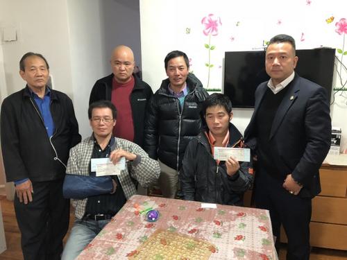 中国侨网美国外卖从业者联合总会会长陈键榕(右一)带领美国外卖从业者联合总会骨干成员,为陈香仪(坐者右)、翁联华(坐者左)送上同行们的善款。(美国《世界日报》/洪群超 摄)