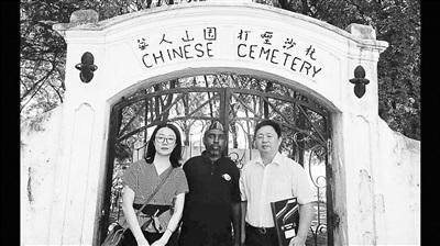 中国侨网朱金峰（右一）、小梦与看顾墓园的教师在墓园门前