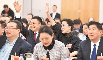 中国侨网图为2019年北京市两会期间,在以科技创新为引领,推动首都经济高质量发展专题座谈会上,与会人士积极举手发言。 阎 彤摄