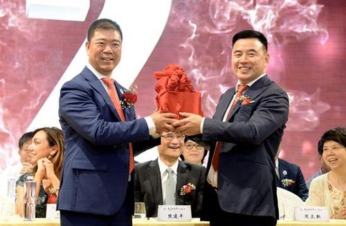 中国侨网新任会长周立新(左)和老会长李秀桐交接会印。(图片来源:意欧联社 赵建斌/摄)