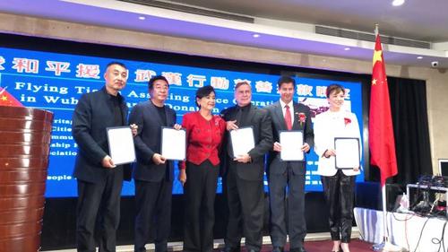 中国侨网赵美心(中)为募捐活动主办方代表颁发感谢状。(美国《侨报》/高睿 摄)