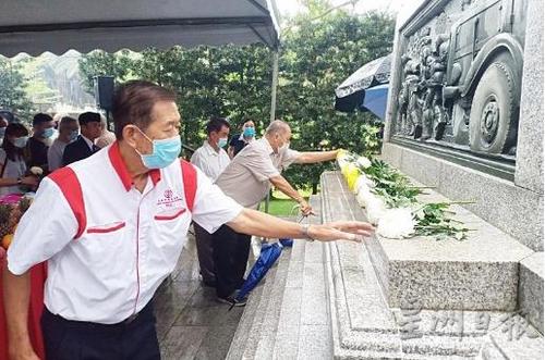 中国侨网马来西亚华团代表在纪念碑前献花。（星洲日报）