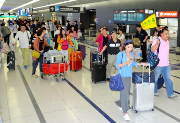中部机场里，众多手拉行李箱的中国团队游客（图片来源：日本《朝日新闻》网站）