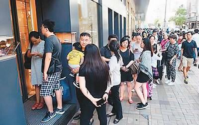 中国侨网“黄金周”期间,尖沙咀名店生意火爆,不少内地旅客在外排队等候。 谭达明摄