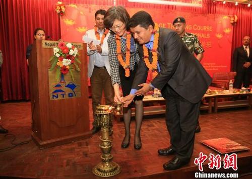 中国侨网中国驻尼泊尔大使于红，尼泊尔文化、旅游与民航部部长阿迪卡里为开班仪式点灯。　张晨翼　摄