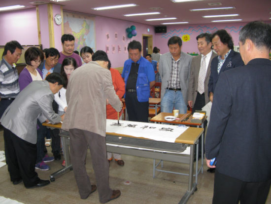 中国侨网向现场嘉宾展示书法技艺
