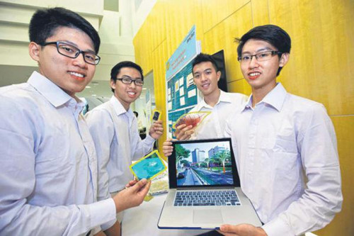 华侨中学(高中部)学生佘志凯(左起)、陈南天、林城议和张世廷采用有机物质,制成一种染料敏化太阳能电池。图为学生展示产品原型和“太阳能树”构想图。(新加坡《联合早报》/曾道明