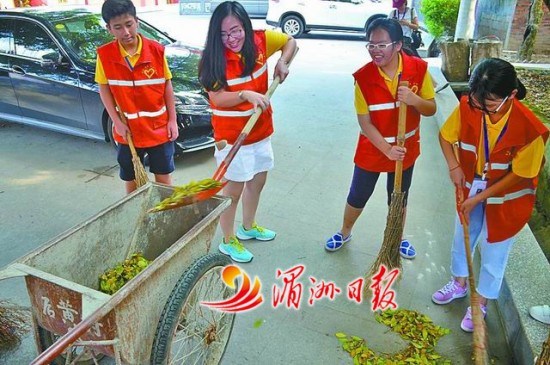图为侨界青年在后黄社区打扫卫生。