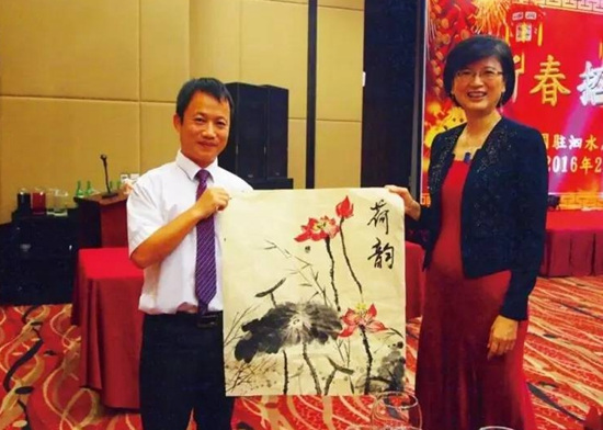 2016年在印尼泗水总领事迎春春节招待会上,张立(左)作画赠给总领事于红。