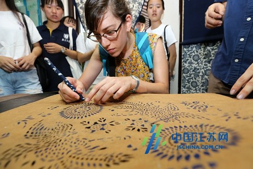2016年8月2日，以色列大学生芳芳在南通蓝印花布博物馆体验蓝印花布印染工艺刻版。（许丛军摄