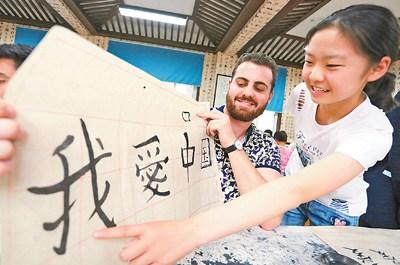 中国侨网图为来自澳大利亚的支教生展示自己书写的毛笔字。 人民视觉