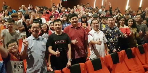 中国侨网观众们在电影播放前合照留念，前排左四起为张赈琮、陈祈升、胡荣兴及马纹郡。（马来西亚《星洲日报》）