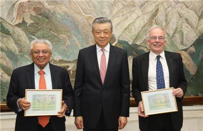 中国侨网刘晓明为巴塔查雅(左)和桑德斯(右)颁发R字签证。图片来源：中国驻英国大使馆网站