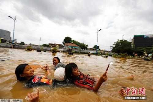  印尼首都雅加达遭暴雨侵袭 儿童在洪水里“苦中作乐”