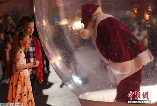 预防新冠病毒！圣诞老人置身“气球”与游客互动