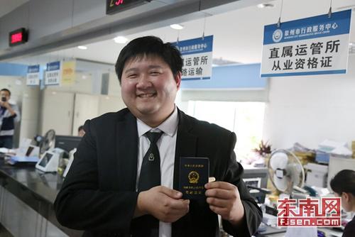 中国侨网谢安源向记者展示《网络预约出租汽车驾驶员证》